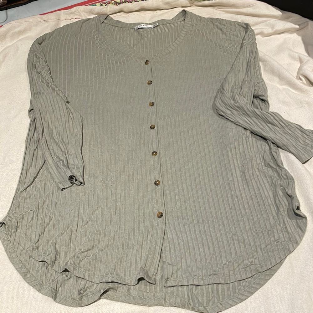Ricki’s long sleeved, button down. T-shirt like material.